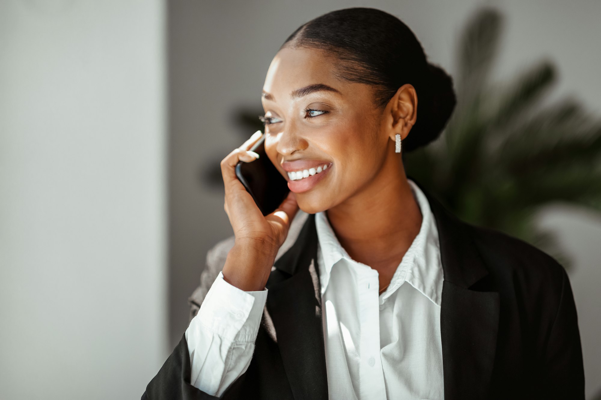 Closeup portrait of black businesswoman talking on phone in office, enjoying business conversation